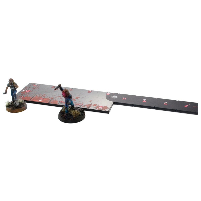 May include: A black and white game board with red blood splatter and numbers. Two miniature figures are standing on the board. One figure is holding a knife.