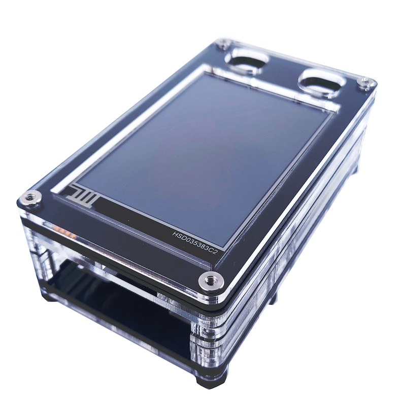 May include: A clear plastic case with a black screen inside. The screen has the text "HSD035383C2" on it.
