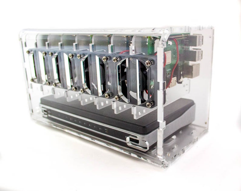 May include: A clear acrylic case with a black hard drive and multiple small fans. The case has a circuit board with red and black wires inside.