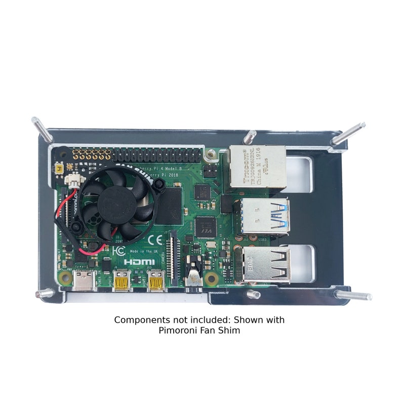 May include: A green Raspberry Pi 4 Model B computer board with a black fan, a black case, and four silver standoffs. The board has a HDMI port, a micro USB port, and an Ethernet port. The text "Raspberry Pi 4 Model B" and "C.H.I.P.S. 2018" are visible on the board.