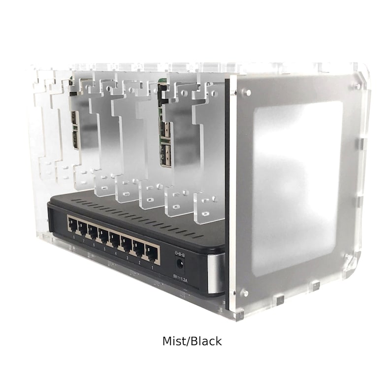 May include: A clear acrylic case with a black network switch and five slots for Raspberry Pi boards. The case has a frosted finish and the text "Mist/Black" is printed on the bottom.