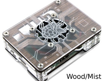May include: A clear acrylic case with a wood grain design for a Raspberry Pi computer. The case has a built-in fan and a cutout for the Raspberry Pi logo. The case is labelled "Wood/Mist".