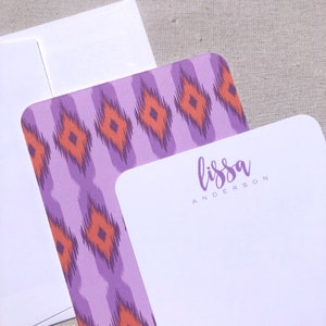 May include: Purple and orange patterned stationery with a white border and the name "lissa anderson" written in purple script.