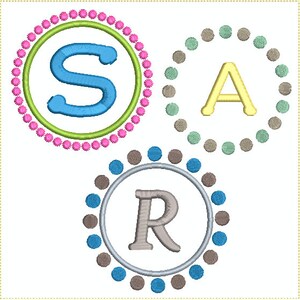 May include: Three embroidered circles with a pink, green, and blue dotted border. Each circle contains a letter, S, A, and R, in a different color.