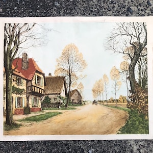 May include: A vintage print of a quaint village scene with a red-roofed house, a thatched-roof cottage, and a dirt road lined with trees. The trees are in autumn colors, with shades of yellow, orange, and brown. The sky is a pale blue, and the sun is shining.