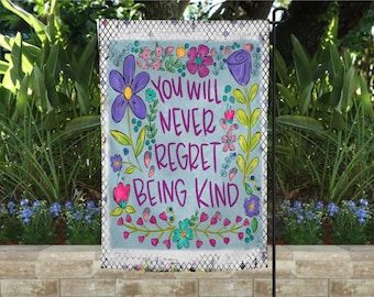 May include: A colorful garden flag with a floral design and the text "You will never regret being kind".