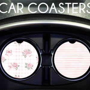 May include: Two car coasters, one with a pink and white gingham pattern with pink roses and bows, and the other with a pink and white striped pattern.