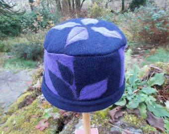 purple and navy blue woolly hat with leaf design