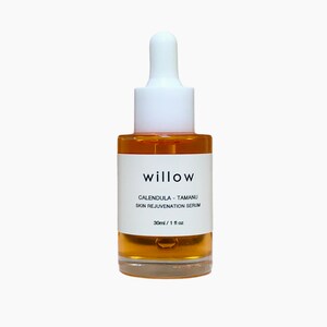 May include: A clear glass bottle with a white dropper top and a white label. The label reads "willow calendula - tamanu skin rejuvenation serum 30ml / 1 fl oz".