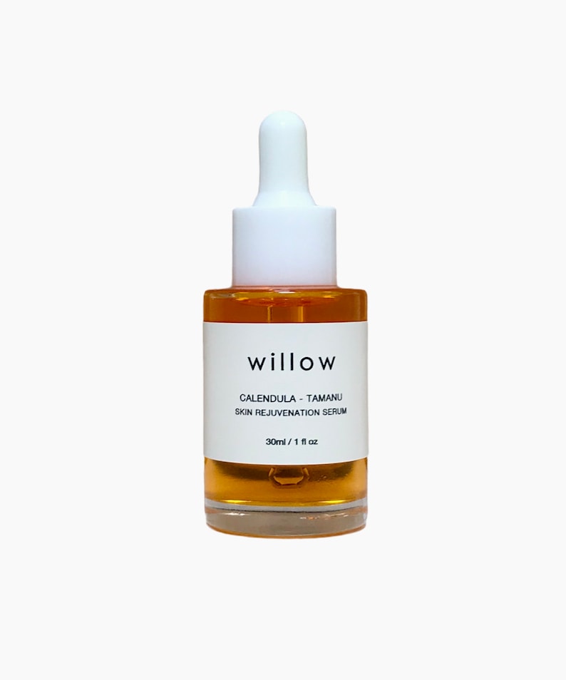 May include: A clear glass bottle with a white dropper top and a white label. The label reads "willow calendula - tamanu skin rejuvenation serum 30ml / 1 fl oz".
