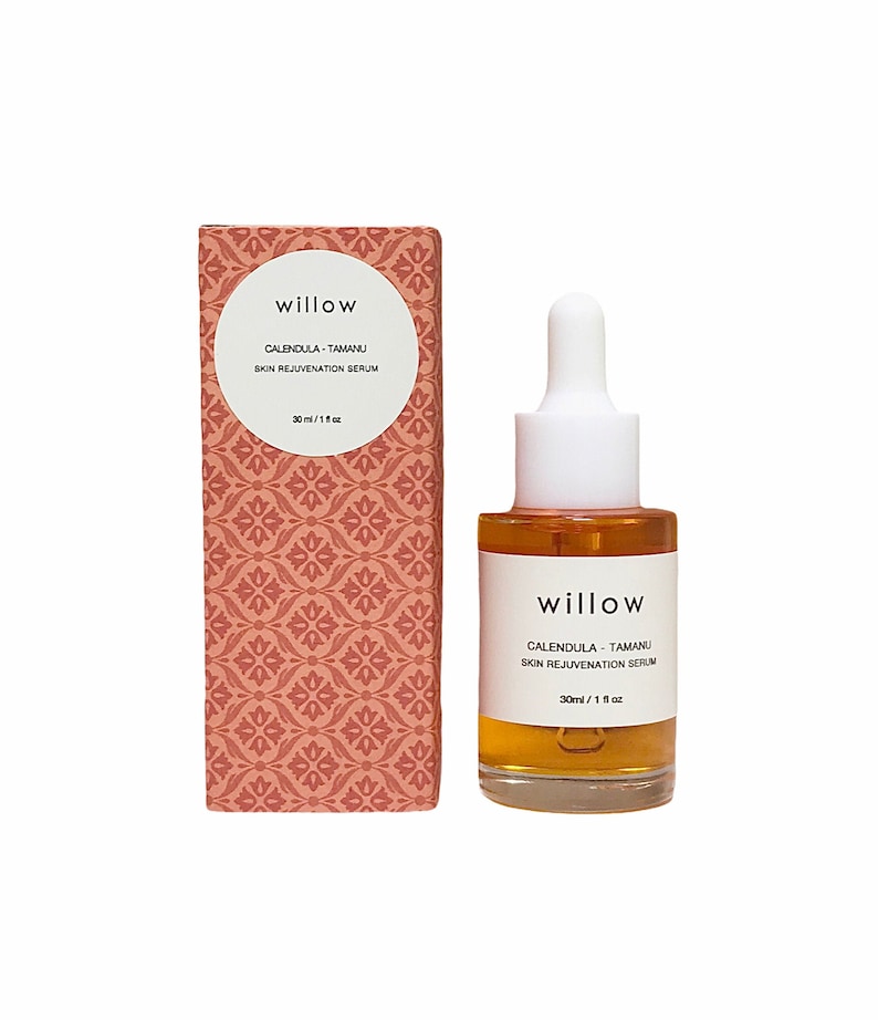 May include: A glass bottle of amber-colored serum with a white dropper and a white label that reads "willow CALENDULA-TAMANU SKIN REJUVENATION SERUM 30ml/1 fl oz". The bottle is sitting on a white background.