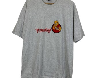 May include: A gray t-shirt with a red circle and a cartoon Tweety Bird graphic. The text "Tweety" is in red letters below the graphic.