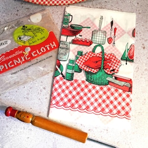 May include: A vintage picnic-themed set featuring a red and white checkered picnic cloth, a plastic picnic cloth, and a wooden tool. The picnic cloth has illustrations of barbecue items. The plastic cloth is 54 x 72 inches.