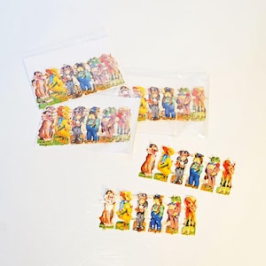 May include: Several sets of vintage paper die-cut figures, featuring anthropomorphic animals in various outfits. The figures are in clear plastic bags and loose, with a colorful, detailed design. The figures include a fox, duck, and frog.