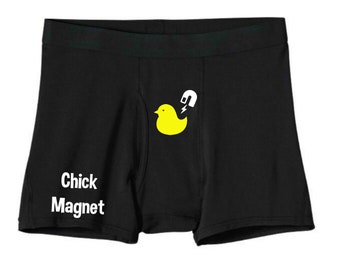 May include: Black boxer briefs with a yellow rubber ducky graphic and the text "Chick Magnet" printed on the front.