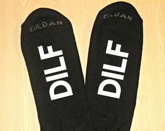 May include: A pair of black socks with the word "DILF" printed in white on each sock. The socks are made by Gildan.