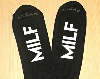 May include: A pair of black socks with the word "MILF" printed in white on each sock. The socks are made by Gildan.