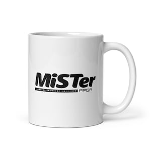May include: White ceramic coffee mug with a black Mister FPGA logo printed on the front.
