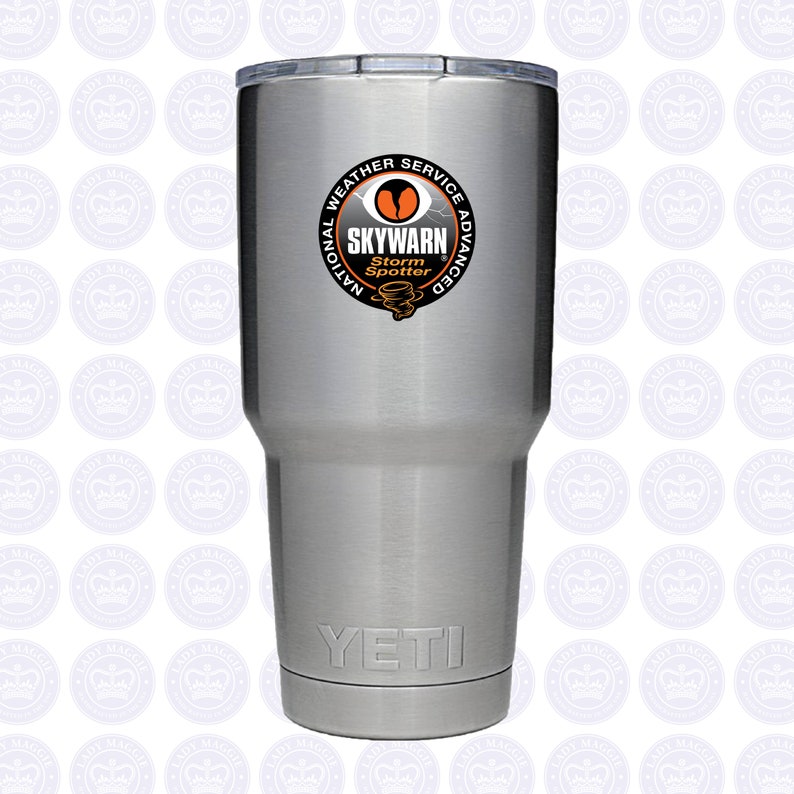 May include: A silver Yeti tumbler with a black and orange sticker that says "National Weather Service Advanced SKYWARN Storm Spotter".