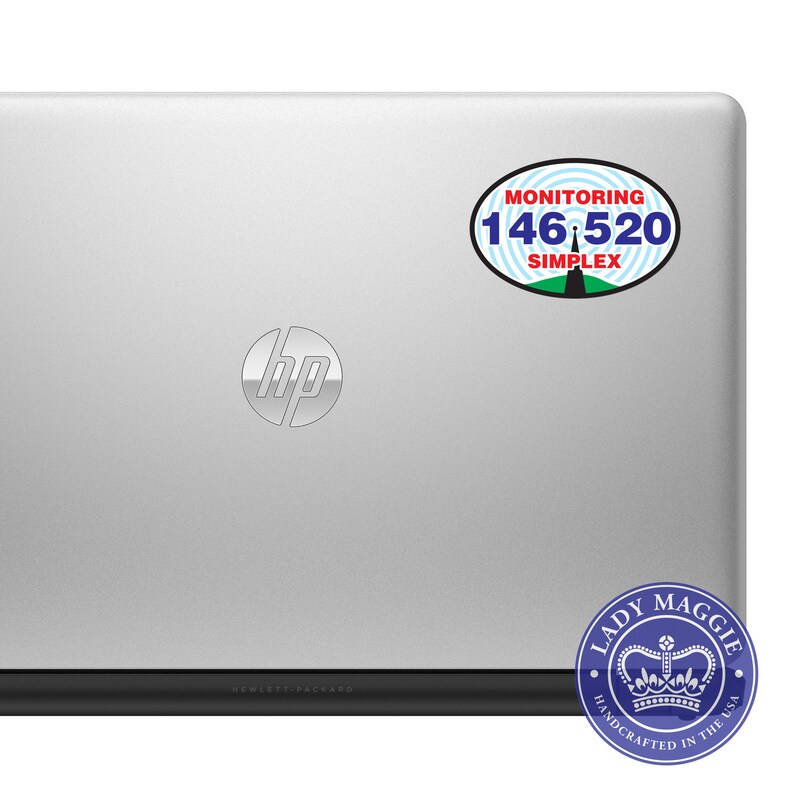 May include: A silver laptop computer with a blue and red sticker that says "Monitoring 146.520 Simplex" and a blue and white sticker that says "Lady Maggie Handcrafted in the USA".