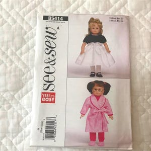 May include: A See & Sew B5414 sewing pattern envelope featuring two doll outfits. The top image shows a doll in a black and white dress. The bottom image shows a doll in a pink patterned robe and pants. The text includes See & Sew, B5414, and Yes! It's Easy.