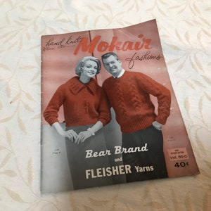 May include: A vintage knitting pattern booklet featuring a couple wearing red sweaters. The cover reads "hand knit Mokair fashions Bear Brand and Fleisher Yarns" and "Vol. 55-C 40 cents".