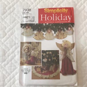 May include: A Simplicity Holiday pattern collection featuring angel ornaments. The cover shows images of finished angels, a tree skirt, and other festive decorations. The pattern includes various angel designs for seasonal crafting.