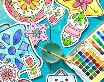 May include: A set of colorful paper ornaments with floral and geometric designs. The ornaments are ready to be painted with watercolors. The set includes a star, a heart, a snowflake, a flower, and a bell.