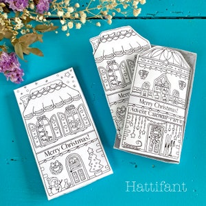 May include: Black and white printable Christmas advent calendar with a gingerbread house design. The calendar has the text "Merry Christmas! Advent Calendar - Part II" on the front.