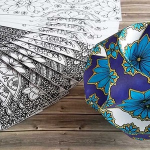 May include: A set of 18 black and white mandala coloring pages with a blue, white, and gold geometric paper sphere with a floral pattern.