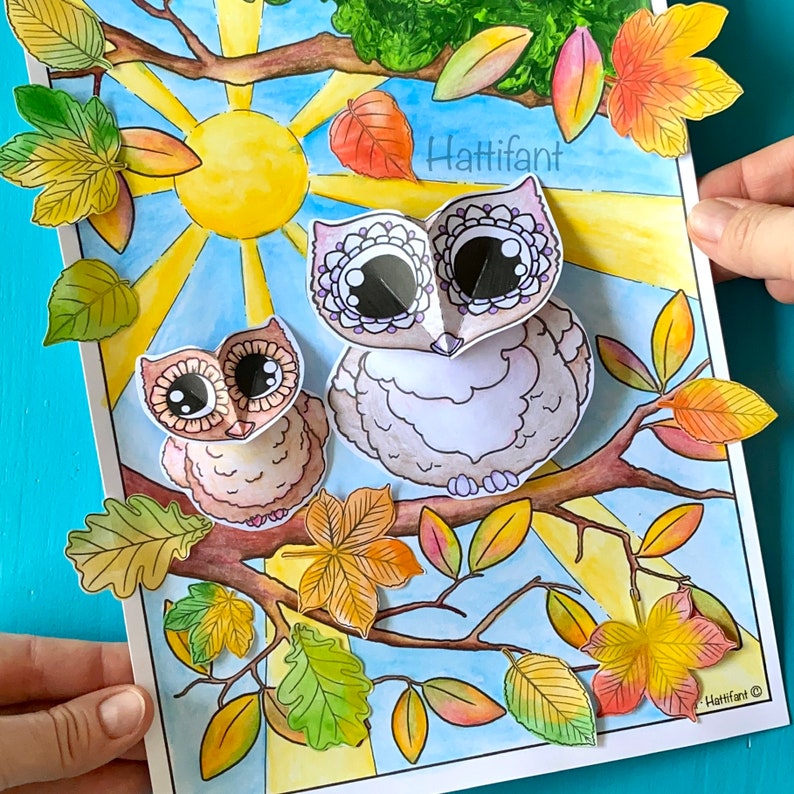 May include: A colorful illustration of two owls perched on a branch with autumn leaves. The owls have large eyes and are surrounded by a bright yellow sun and blue sky. The text "Hattifant" is visible in the upper right corner.