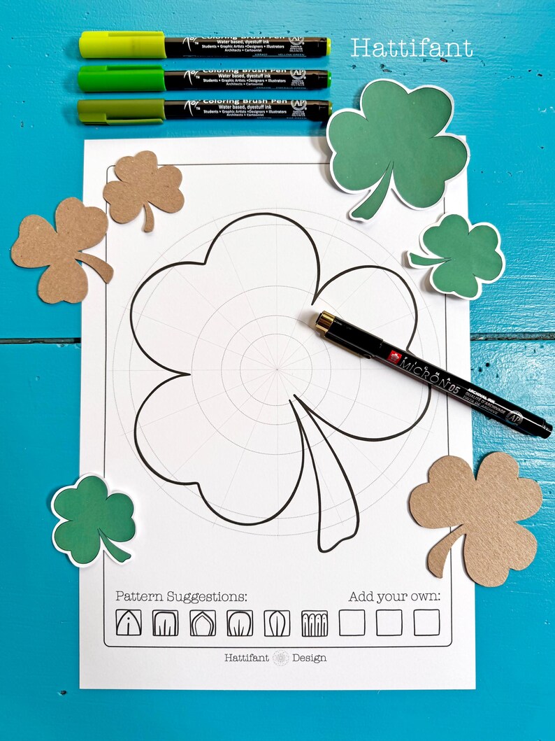 May include: A printable colouring page featuring a shamrock with a grid pattern. The page includes pattern suggestions and space to add your own designs. The text "Hattifant Design" is at the bottom of the page.