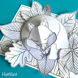 May include: A black and white line drawing of a fox sleeping on a bed of leaves. The fox is curled up with its head resting on its paws. The leaves are arranged around the fox in a circular pattern.