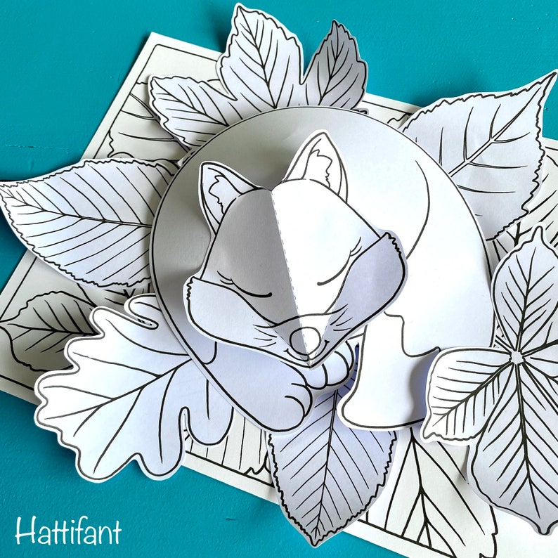 May include: A black and white line drawing of a fox sleeping on a bed of leaves. The fox is curled up with its head resting on its paws. The leaves are arranged around the fox in a circular pattern.