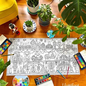 May include: A black and white coloring page featuring a Christmas scene with gingerbread houses, nutcrackers, and a carousel. The page is surrounded by paintbrushes, watercolors, and a color wheel.