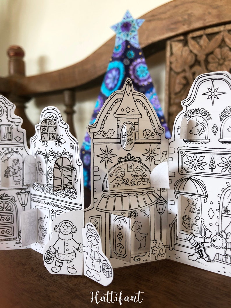 May include: A black and white printable paper craft advent calendar featuring a row of houses with doors and windows. The houses are decorated with stars, snowflakes, and other festive details. The calendar is designed to be cut out and assembled.