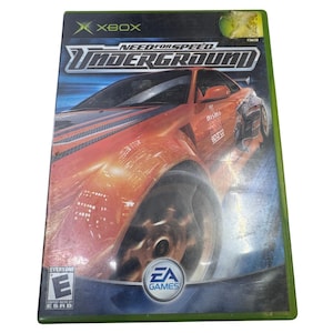 May include: An Xbox video game case for Need for Speed Underground featuring a bright orange sports car on the cover. The artwork displays the game title in bold white lettering, the EA Games logo, and an ESRB Everyone E rating symbol.