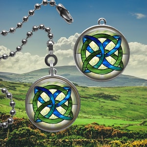 May include: Two silver ceiling fan pull chains with round, green, blue, and white stained glass Celtic knot designs.