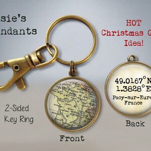 May include: A two-sided key ring with a map of France on one side and coordinates and the text "49.0167&deg;N 1.3828&deg;E Pacy-sur-Eure, France" on the other side. The key ring is made of brass and has a vintage look.