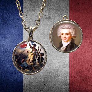May include: A gold chain necklace with two round pendants. One pendant features a painting of a woman holding a flag, while the other pendant features a portrait of a man with powdered hair.