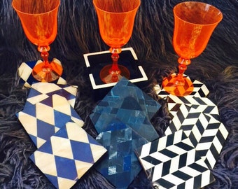 Chic 4 Piece Coaster Sets in Choice of Bone Diamond Patterns over Wood Bases.