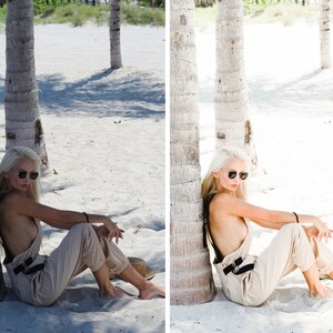 Puede incluir: Una mujer con un mono beige y gafas de sol se sienta en una playa de arena con palmeras en el fondo.