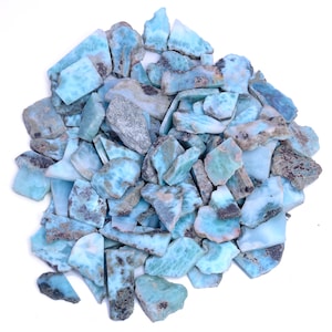 Puede incluir: Un montón grande de piedras preciosas azules y verdes. Las piedras tienen una forma irregular y un aspecto moteado.