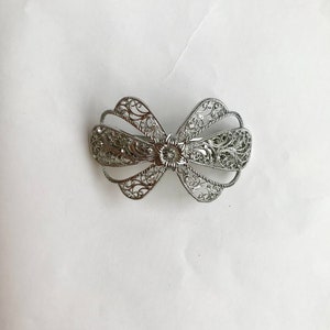 Curved metal clip/ barrette with diamanté in silver colour
