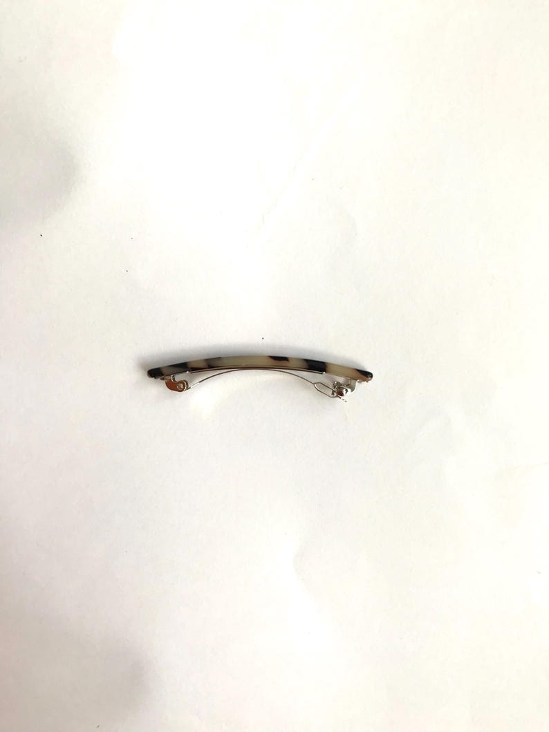 May include: A tortoiseshell hair clip with a silver metal clasp.