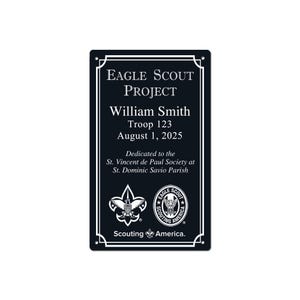 May include: A black rectangular plaque with white text and decorative borders. The text reads "Eagle Scout Project," the name "William Smith," troop number, and the date August 1, 2025. Includes the Scouting America logo.