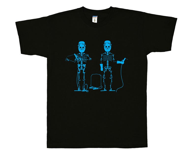 May include: A black short-sleeve t-shirt featuring a bright blue graphic print of two skeletons wearing welding helmets and holding welding equipment, with a small rectangular welding machine positioned between them on the chest area.