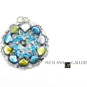 May include: A round pendant with a blue, green, and silver iridescent design. The pendant features a clear crystal in the center and is surrounded by smaller iridescent beads.