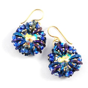 May include: A pair of gold earrings with blue and purple iridescent beads. The beads are arranged in a circular pattern, creating a flower-like design.