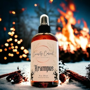 May include: A brown glass bottle with a black spray nozzle and a white label. The label says "Curiosity Cabinet Apothecary" and "Krampus". The bottle is 8 oz or 236 ml and says "External Use Only".